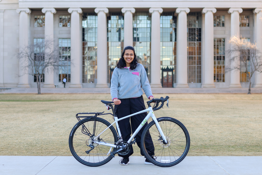 Spokes team member with bike near building 10